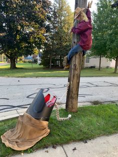 a person sitting on top of a telephone pole next to a trash bag wrapped around it