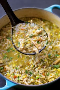 a ladle full of chicken and rice soup