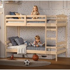 two children sitting on bunk beds in a bedroom