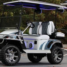 a white and blue golf cart parked in a parking lot