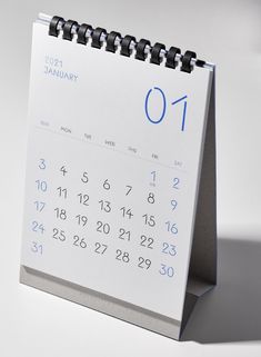 a calendar with the number 01 on it is sitting in front of a white background