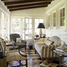 a living room filled with furniture and lots of windows