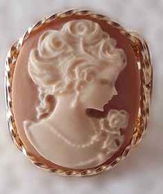 Fine Lady Cameo hand sculpted from the finest Jeweler's 14k Gold Filled in Artistic Designed Setting. Fine Lady blending into a coffee background. Lightweight and easy to wear.  ~This unique artisan handmade Cameo ring is one of a kind!  ~This is a classy fine handcrafted sturdy Cameo ring!  ~This ring is great for casual or dressy wear!  ~You will receive one like the pictures!  Top of Ring Dimensions: 1" x 3/4"  Band width is 1/4" and 2mm thick  Cameo Size: 25x18mm  Cameo type: Fashion Resin Cheap Gold Cameo Jewelry, Luxury Cameo Jewelry For Memorial, Luxury Cameo Jewelry For Wedding, Luxury Cameo Jewelry For Gift, Luxury Cameo Jewelry Gift, Cameo Jewelry Dog, Luxury White Cameo Jewelry, Luxury Cameo Round Jewelry, Luxury Antique Cameo Jewelry