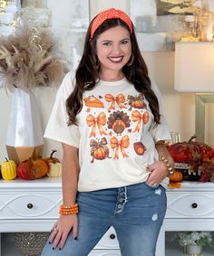 The All Things Thanksgiving Graphic Shirt is a delightful way to celebrate the holiday season! This shirt showcases an adorable design featuring a pumpkin pie, a pumpkin adorned with a leopard bow, a turkey, a cup of coffee, and charming bows, all beautifully displayed on a natural fabric. Available in both short sleeve and long sleeve options, this shirt is perfect for family gatherings and Thanksgiving festivities. Show your love for all things Thanksgiving while staying cozy and stylish this turkey day! Thanksgiving Festivities, Turkey Day, Natural Fabric, A Cup Of Coffee, Graphic Shirt, A Pumpkin, Family Gatherings, Cup Of Coffee, Family Gathering