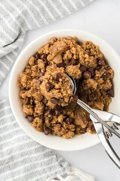 a bowl filled with oatmeal and chocolate chips on top of a table