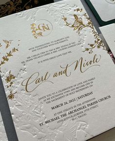 an ornate wedding card with gold foil on it