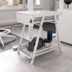 a computer desk with a mouse and keyboard on it in a white room next to a chair