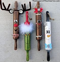 three christmas decorations made out of toilet paper tubes, one with reindeer noses and the other with snowmen nose