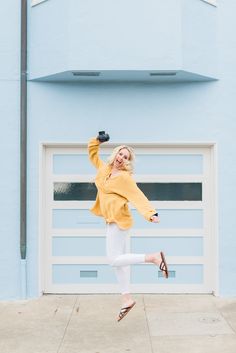 a woman jumping in the air with her legs spread