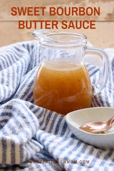 sweet bourbon butter sauce in a glass pitcher on a blue and white towel with a spoon