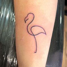 a small flamingo tattoo on the left arm and leg, it is black with pink ink