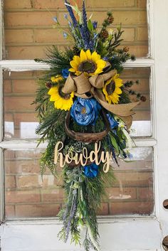 a door hanger with sunflowers, grass and the word ready on it