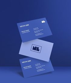 two business cards stacked on top of each other in front of a dark blue background