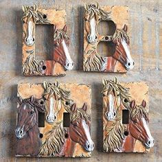 four horse head switch plates on a wooden surface