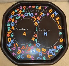 a black tray with letters and numbers on it