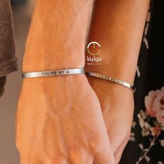 two people wearing bracelets that say you're my love