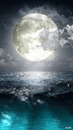 a full moon over the ocean on a cloudy night