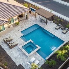 an aerial view of a pool and patio area