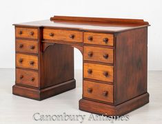 an antique wooden desk with drawers on it