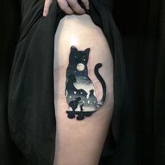 a person with a cat tattoo on their arm