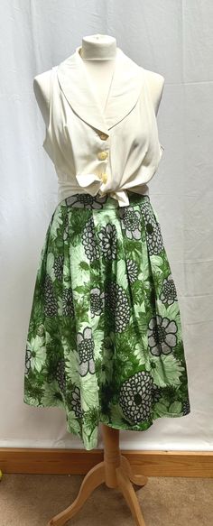 Vintage Rare Find  Hand Made 1950 A-Line Box Pleat,  Full, Swing Style Skirt in lovely, good weight cotton. Beautiful, Vibrant Shades of Greens and Black Outlined Floral Pattern.  The waistband is deep, metal side zip, wide box pleats giving a full swing style. Mid Calf Length but there is a large Hem so could be made longer. Measures : Appropriate  Waist 28/29". UK Size 10 Length 26" In fabulous Condition, no stains, rips or tares. Rare Find Cotton A-line Skirt With Floral Print, Retro Green A-line Skirt, Vintage Retro Print Skirt For Spring, Vintage Skirt With Retro Print For Spring, Retro Flared Skirt With Floral Print, Vintage Fitted Cotton Skirt, Vintage Skirt For Garden Party, Vintage Retro Print Summer Skirt, Fitted Green Skirt For Garden Party