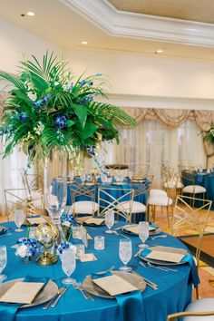 the tables are set with white and blue linens