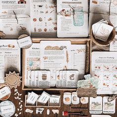 an assortment of items displayed on top of a wooden table with papers and other items