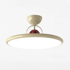 a white ceiling light with a red ball hanging from it's center point,