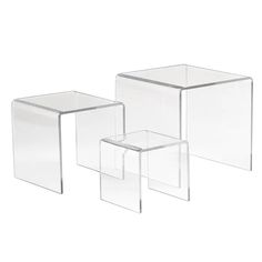 three clear glass side tables on a white background