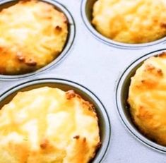 four muffins in a pan with cheese on top