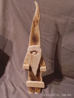 a wooden figurine with a long beard and mustache