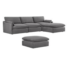 a gray couch and ottoman sitting on top of a white floor next to each other