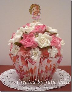 a cupcake decorated with pink and white flowers