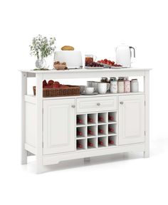 a white buffet table with food and drinks on it's top shelf in front of the counter