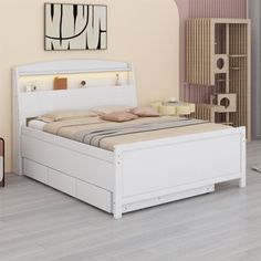 a white bed sitting on top of a hard wood floor