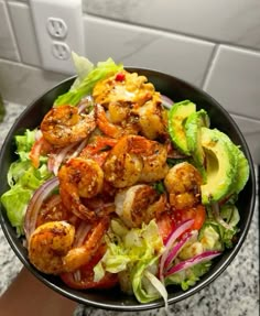 a salad with shrimp and lettuce in a bowl