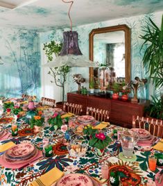 a dining room table is set with plates and place settings