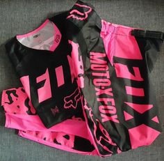 two pink and black shorts laying on top of each other