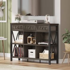 a living room scene with focus on the entertainment center and wall hanging in the background