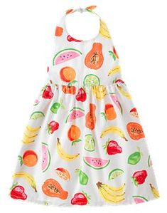 a white dress with fruits and vegetables on the front, as if it were for a baby