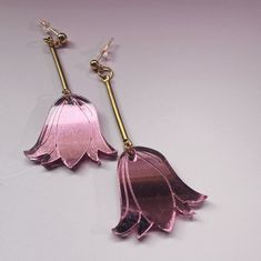 Expertly crafted from pink mirror acrylic and brass, these Sabrine Tulip Earrings feature a 14k gold-filled stud and measure a sleek and stylish 2-1/4 inches in length. Every piece of jewelry is hand formed and hand assembled by me. Due the unique nature of the product you may not get the pictured earrings. Tulip Earrings, Black Glaze, Pink Mirror, Mirror Acrylic, Black Stud, Floral Hoops, Earthenware Clay, Unique Nature, Steel Post