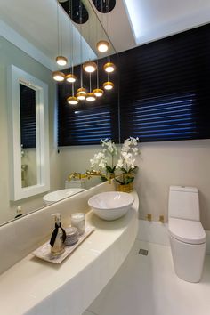 a bathroom with a sink, toilet and mirror