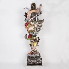 a statue made out of various objects on a white background