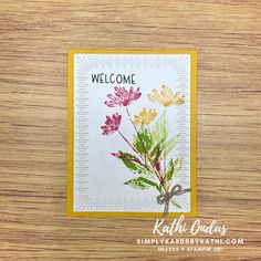 a welcome card with flowers on it