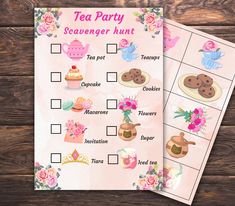 two tea party scavengers on top of a wooden table with pink flowers