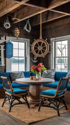 a living room with blue couches and wooden tables in front of two large windows