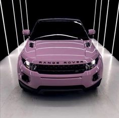 a pink range rover parked in a garage