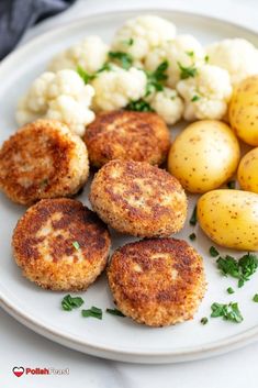 there are some crab cakes and potatoes on the plate