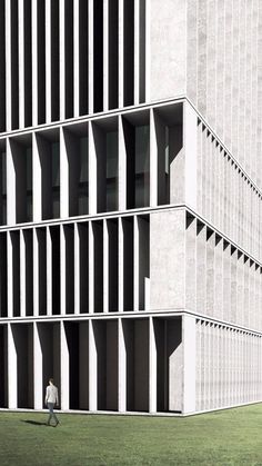 two people walking in front of a tall building