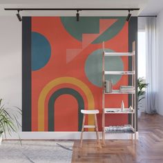 an orange and green abstract painting on a wall in a room with wooden flooring